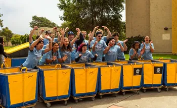 CSUMB Otter Welcome Team cheering with bins for Move In day