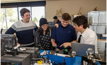 A group of four mechatronics students grouped together collaborating