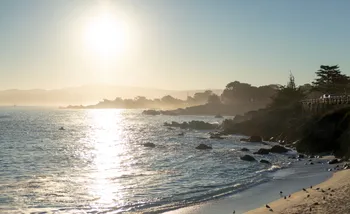 Beach scene with sun shining above