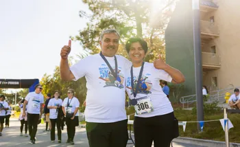 2 runners smiling at finish line