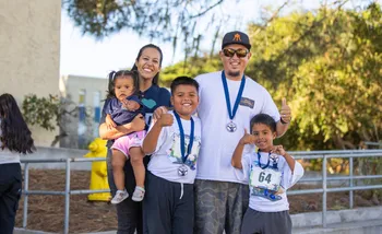 Family with children posing at race finish