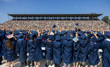 Students wave to families at Commencement