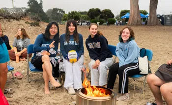 Students enjoy a beach bonfire to warm up after the Plunge at Del Monte beach
