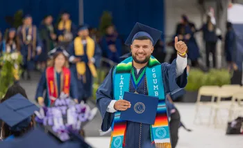 Male CSUMB Students Smiling while doing a thumbs up
