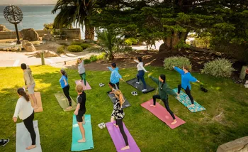 Students practicing yoga outdoors
