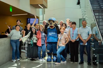 Group of iiED staff and students with CSUMB Mascot Monte Rey
