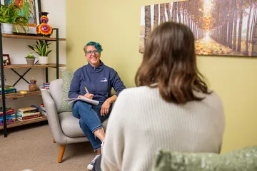 A counselor meets with a student in a supportive one-on-one setting, offering personalized guidance and care.