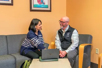 CSUMB special education credential faculty and student meeting together using a laptop