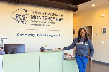 A girl is posing near the reception area of Community Health Engagement