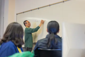 A Teacher is teaching to students