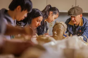 Students doing Pottery with a professor