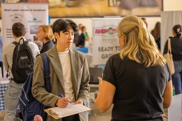 Student meeting with a industry person during career fair