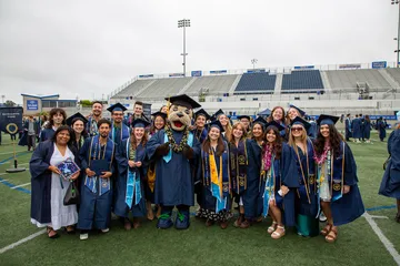 A group of students with Monte at graduation