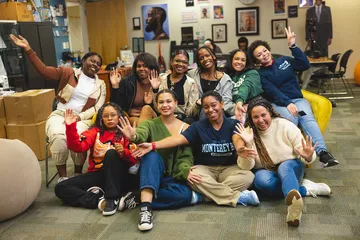 Group of cheering students at the Helen Rucker Center.