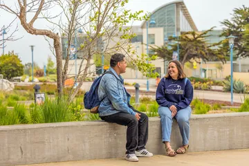 CSUMB students seated outside on campus