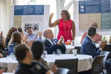 Students are gathering around tables in the room
