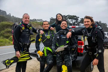 Divers sitting with each other before a dive