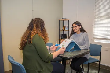 CSUMB student at a reading session with a professor
