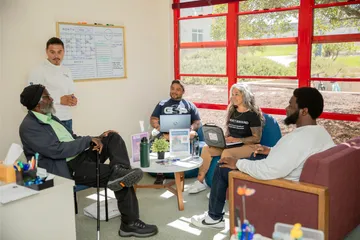 A group of people sitting around a meeting table