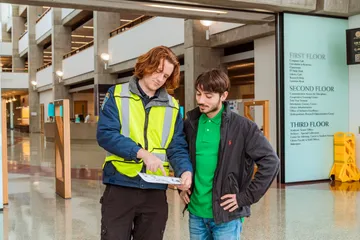 A CSO pointing out directions on a map for a student