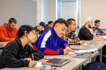 Students are engaged in study within a classroom setting.
