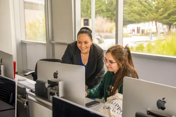 Two team members looking at a computer screen