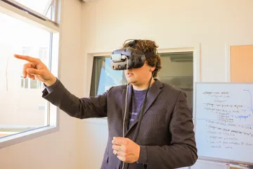 A boy is wearing Virtual Reality glass