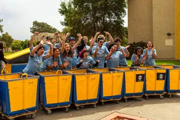 CSUMB Otter Welcome Team cheering with bins for Move In day