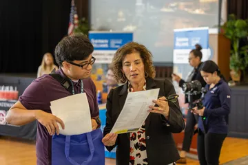 A student and a recruiter talking at a career fair