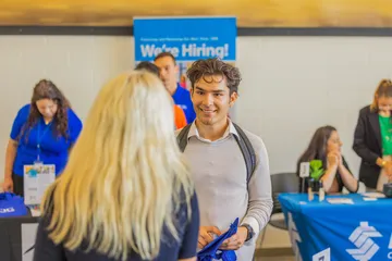 Student talking to an employer at a career fair.