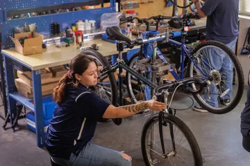 Student fixing a bicycle
