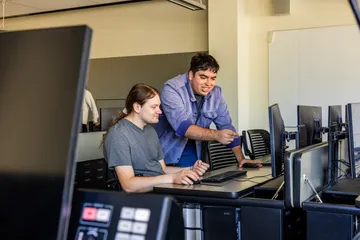 Two students looking at computer