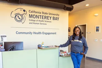 A girl is posing near the reception area of Community Health Engagement
