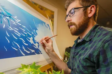 Student painting a seascape