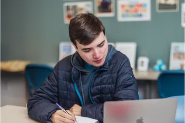 A global studies student taking notes