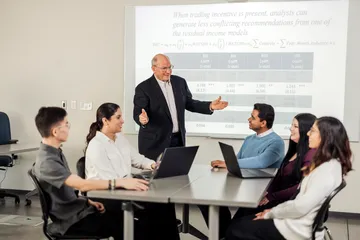 An accounting professor presents to a class