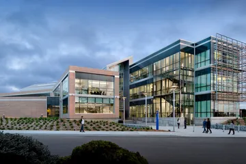 Bit building with expansive glass design, reflecting innovation and a dynamic learning environment.