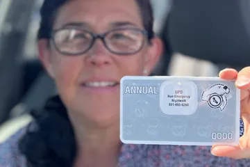 Women holding a parking permit