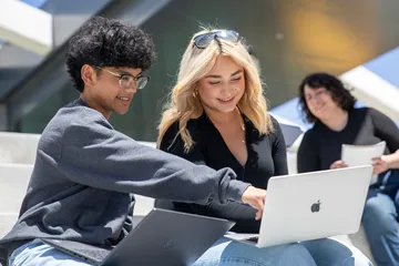 2 csumb students on their computer at the OSU