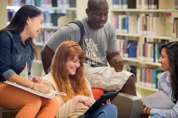 A photo of the CSUMB students reading in the library