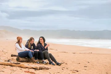 students laying down at the beach