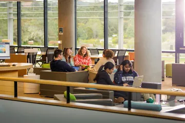 The University Communications team meeting in the library
