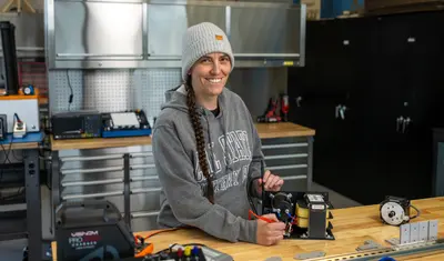 A girl working with the machine and smiling
