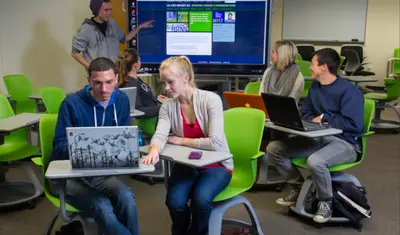 Business Minor students in green rolling chairs