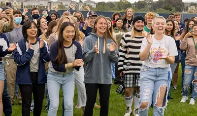 A large group of students clapping in excitement.