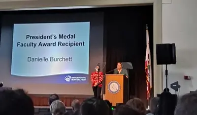 danielle burchett and president on stage
