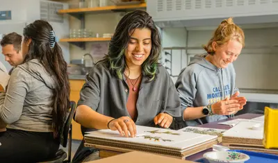 Students smiling doing crafts