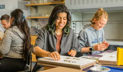 Students smiling doing crafts