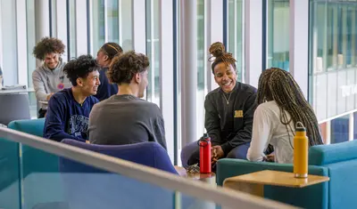 Students at College of Arts, Humanities and Social Sciences building