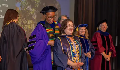 A MSW student getting hooded at their graduation